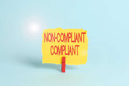 Hand writing sign Non Compliant Compliant. Business showcase Resistant to the Rule in Accordance to Law Colorful Office Supplies Bright Workplace Stuff Workshop Materialsの写真素材