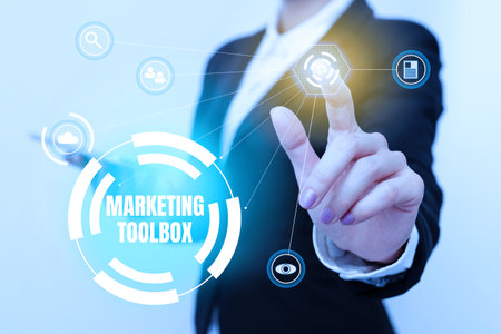 Sign displaying Marketing Toolbox. Internet Concept Means in promoting a product or services Automation Woman In Uniform Carrying Phone And Tapping Futuristic Display.の写真素材