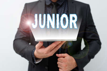 Writing displaying text Junior. Word for erson who is a specified number of years younger than...