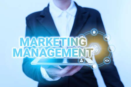 Writing displaying text Marketing Management. Word for Develop Advertise Promote a new Product or Service Woman In Suit Standing Using Device Showing New Futuristic Virtual Tech.の写真素材