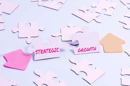 Inspiration showing sign Strategic Growth. Internet Concept create plan or schedule to increase stocks or improvement Building An Unfinished White Jigsaw Pattern Puzzle With Missing Last Pieceの写真素材