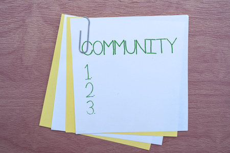 Handwriting text Community. Business idea group of showing with a common characteristics living together Multiple Assorted Collection Office Stationery Photo Placed Over Tableの写真素材