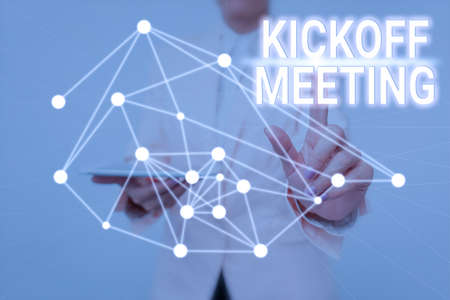 Writing displaying text Kickoff Meeting. Business showcase Special discussion on the legalities involved in the project Lady Holding Tablet Pressing On Virtual Button Showing Futuristic Tech.の写真素材