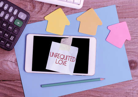 Text sign showing Unrequited Love. Business idea not openly reciprocated or understood as such by beloved Display of Different Color Sticker Notes Arranged On flatlay Lay Backgroundの写真素材