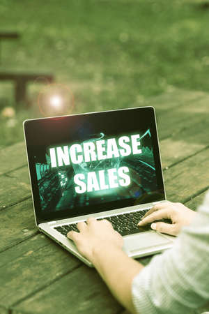 Conceptual caption Increase Sales. Word for Boosting the product sold to customers Trade Growth Laptop Placed Resting On Table Working In The Park Doing Remote Jobs.の写真素材