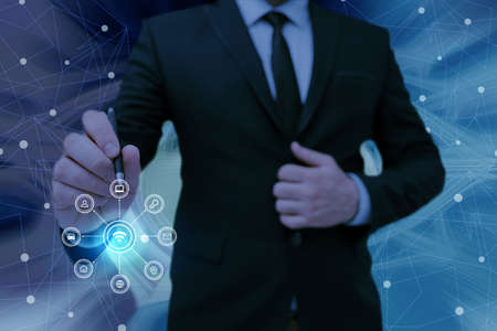 Man holding Screen Of Mobile Phone Showing The Futuristic Technology. Businessman Presenting Cell Phone Inside Room Presenting Modern Automation.の写真素材