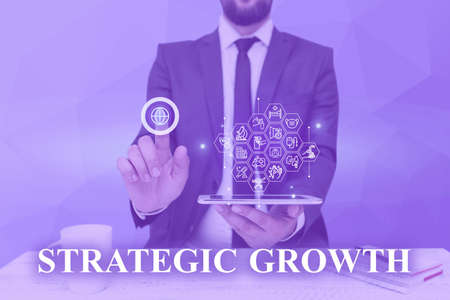 Hand writing sign Strategic Growth. Business showcase create plan or schedule to increase stocks or...