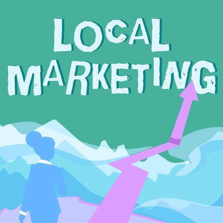 Conceptual caption Local Marketing. Word Written on A local business where a product buy and sell in area base Lady Walking Towards Mountains With An Arrow Marking Successの写真素材