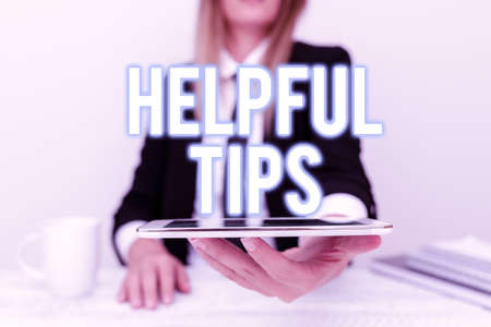 Text showing inspiration Helpful Tips. Business idea advices given to be helpful knowledge in life App Developer Presenting New Program, Displaying Upgraded Deviceの写真素材