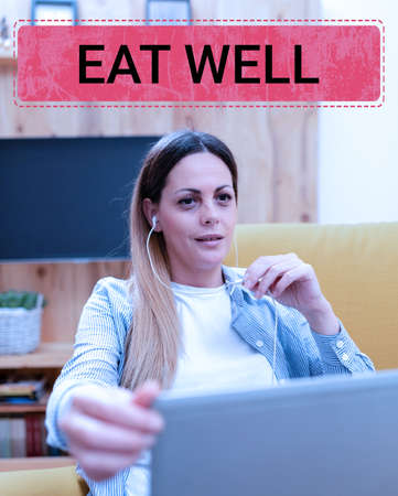 Hand writing sign Eat Well. Conceptual photo Practice of eating only foods that are whole and not processed Watching Online Lessons, Reading Internet Blogs, Learning New Thingsの写真素材