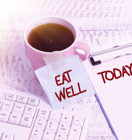 Inspiration showing sign Eat Well. Conceptual photo Practice of eating only foods that are whole and not processed New Coffee Shop Ideas Writing Important Notes Coffee Break Timeの写真素材