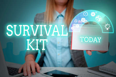 Inspiration showing sign Survival Kit. Word for Emergency Equipment Collection of items to help someone Lady in suit holding notepad representing innovative thinking.の写真素材