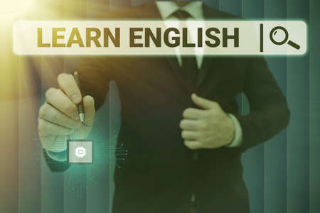 Handwriting text Learn English. Business overview Universal Language Easy Communication and Understand Man holding Screen Of Mobile Phone Showing The Futuristic Technology.の写真素材