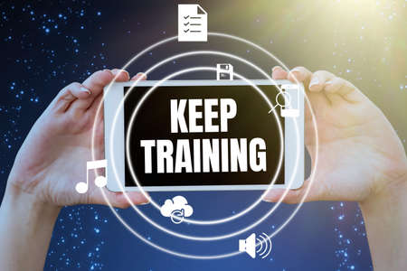 Conceptual display Keep Training. Word Written on Grounding Drilling Always Wonder Be Curious Learn Hands holding tablet presenting innovative ideas symbolizing technology.の写真素材