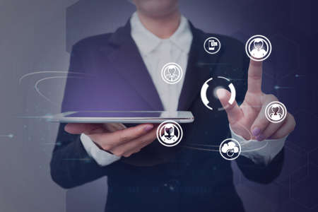 Lady in suit holding tablet symbolizing successful teamwork accomplishing newest project plans....
