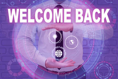 Sign displaying Welcome Back. Business overview Warm Greetings Arrived Repeat Gladly Accepted Pleased Businessman in suit holding open palms represents innovative thinking.の写真素材
