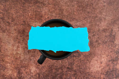 Pastel Color Blank Paper On Cup Of Coffee Over Wooden Background. Empty Sheet Placed Above Mug Drink Displaying Business Advertisement And Brand Promotion.の写真素材