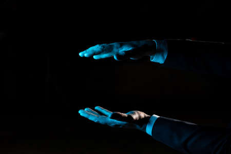Businessman Presenting Important Informations Between Hands. Man In Suit Showing Crutial Updates Among Palms. Executive Holding Critical Announcements.の写真素材