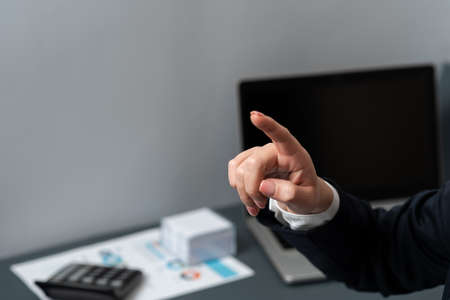 Businesswoman Pointing Important Infortmations With One Finger. Hand Presenting Crutial Announcement. Woman Showing Recent Updates. Executive Displaying Critical Messages.の写真素材