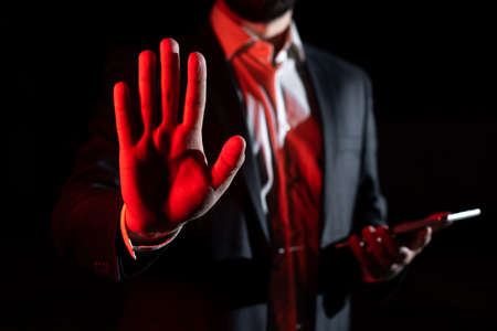 Businessman Holding Tablet And Presenting With Other Hand Important Message. Executive In Suit Presenting Crutial Information. Gentleman Showing Critical Announcement.の写真素材