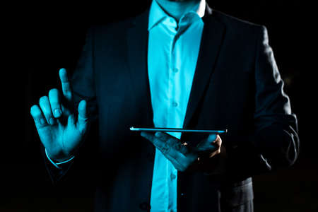 With One Finger Pointing Important Infortmations With Other Hand Holding Tablet. Businessman Showing Recent Updates. Executive Displaying Critical Messages.の写真素材