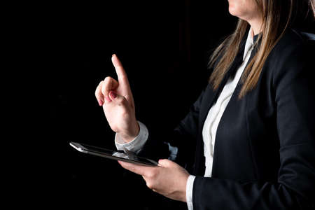 Businesswoman Holding Tablet And Pointing With One Finger On Important Message. Executive In Suit...