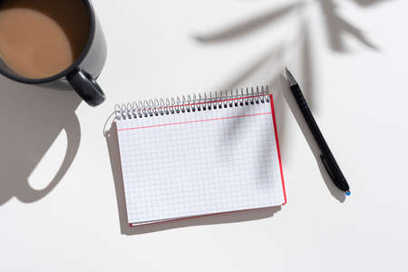 Notebook With Important Messages On Desk With Coffee And Pen. Crutial Informations On Pad On Table...