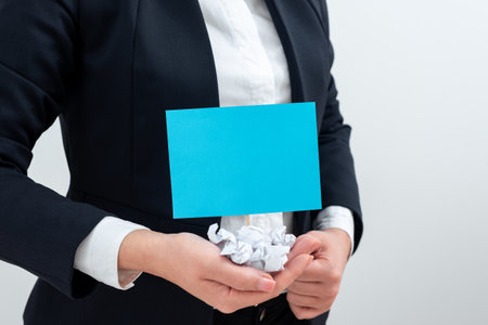 Businesswoman Holding Paper Wraps And Important Message On Stick. Woman Having Crumpled Notes And Crutial Information In Hands. Palms Full With Wrinkled Notepaper And Memo.の写真素材