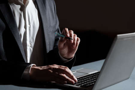 Businessman Typing Important Concept Into Lap Top And Pointing New Idea With Pen. Man In Suit...