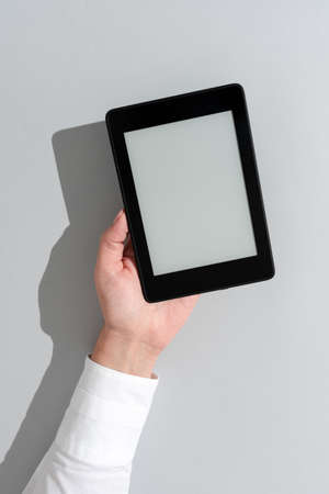Businesswoman Holding Tablet And Presenting Important Informations On It. Woman Showing Recent Updates On Screen. Executive Displaying Late Achievements On Cellphone.の写真素材