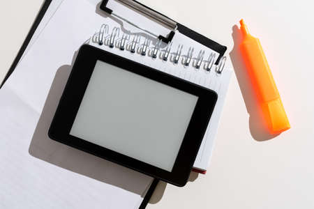 Tablet With Important Message Over Clipboard, Notebook And Marker. Mobile Phone Screen With Crutial Information Above Notes. Presented Critical Updates On Cellphone.の写真素材