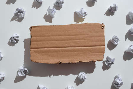 Paper Wraps Placed Under Cardboard With Important Information. Wrinkled Notes Arranged Underneath Paperboard With Crutial Message. Crumpled Memos With Critical Data Above.の写真素材