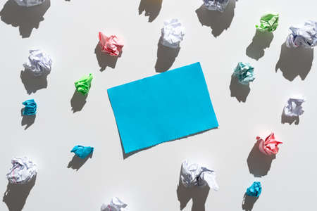 Piece Of Paper With Important Messages Surrounded By Paper Wraps. Crutial Announcement On Paperboard With Crumpled Notes Around. Recent Ideas Presented On Note.の写真素材