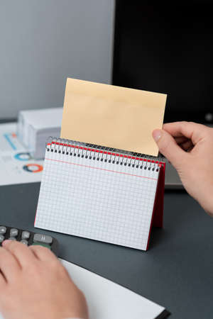 Businesswoman Holding Note With Current Message On Desk With Notebook With New Ideas. Woman In Suit...