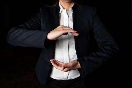 Businesswoman Holding Important Message Between Hands. Woman In Suit Showing New Crutial Idea Among...