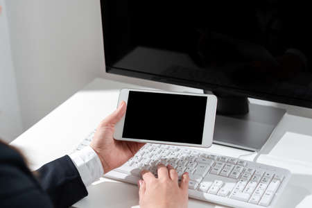 Businesswoman Holding Mobile Phone With Important Announcements Sitting On Desk With Computer. Woman...