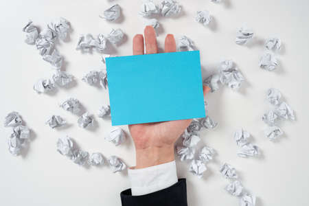 Paper Wraps Underneath Piece Of Paper With Important Message. Crumpled Notes Under Crutial Information. Woman Presenting Recent Updates Above Wrinkled Notepaper.の写真素材