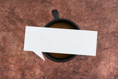Blank Thought Bubble Paper On Cup Of Coffee Over Wooden Background. Empty Sheet Placed Above Mug...