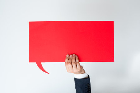 Businessman Holding Speech Bubble With Important Messages With One Hand. Man In Suit Presenting...