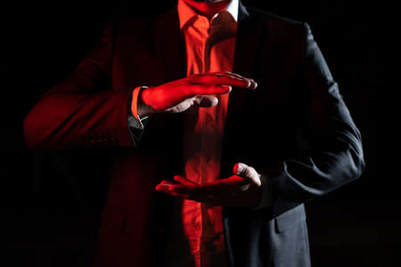 Businessman Presenting Important Informations Between Hands. Man In Suit Showing Crutial Updates...