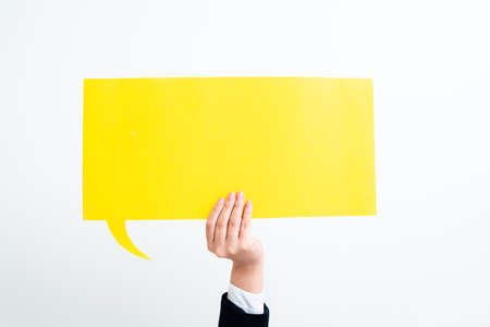 Businesswoman Holding Speech Bubble With Important Messages With One Hand. Woman Presenting Crutial Informations On Dialogue Balloon. Lady Showing Recent Updates On Paper.の写真素材