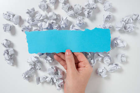 Paper Wraps Underneath Piece Of Paper With Important Message. Crumpled Notes Under Crutial Information. Woman Presenting Recent Updates Above Wrinkled Notepaper.の写真素材