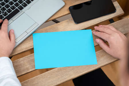 Woman Typing On Lap Top Keyboard, Presenting Important Message On Paper And Phone On Table....