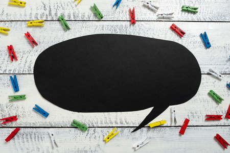 Colorful Pegs Placed Around Speech Bubble With Important Information. Wooden Clips Arranged All Over Dialogue Ballon With Crutial Idea. Pins With Critical Data Inside.の写真素材