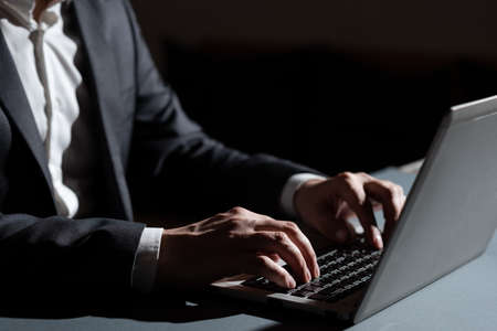 Businessman Typing Important Informations Into Lap Top. Man In Suit Writing Crutial Messages On Computer Keyboard. Executive Entering Recent Data Into Pc.の写真素材
