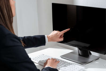 Businesswoman Pointing Important Infortmation With One Finger On Computer. Hand Presenting Crutial...