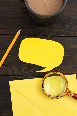 Thought Bubble Paper With Envelope, Coffee Cup And Stationery On Wooden Background. Business Strategies With Drink On Table. It Is Showing Crucial And Important News.の写真素材