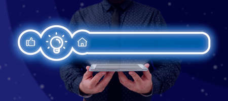 Businessman Holding A Tablet With Glowing Light Bulb And Other Digital Signs In A Graphic Design....