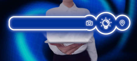 Businesswoman Holding A Tablet With Glowing Digital Symbols And Light Bulb In Abstract Design. Woman With A Pad Showing Important Tips And Information.の写真素材