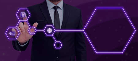 Businessman Pressing On Floppy Disk With Other Signs In Abstract Hexagon Pattern. Man In Suit Displaying Crucial Data On Digital Connectivity And Creativity.の写真素材